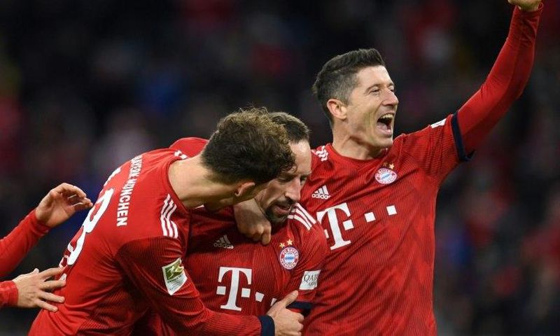 Bayern Munich's Polish striker Robert Lewandowski (R), who scored their first two goals, celebrates after Franck Ribery netted a late third in Saturday's 3-0 win against Nuremberg to lift the defending champions to third in the league table.