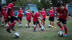 Children attend a football training session in the suburbs of Guangzhou, in southern China's Guangdong province