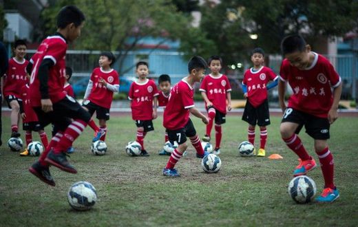 Children attend a football training session in the suburbs of Guangzhou, in southern China's Guangdong province