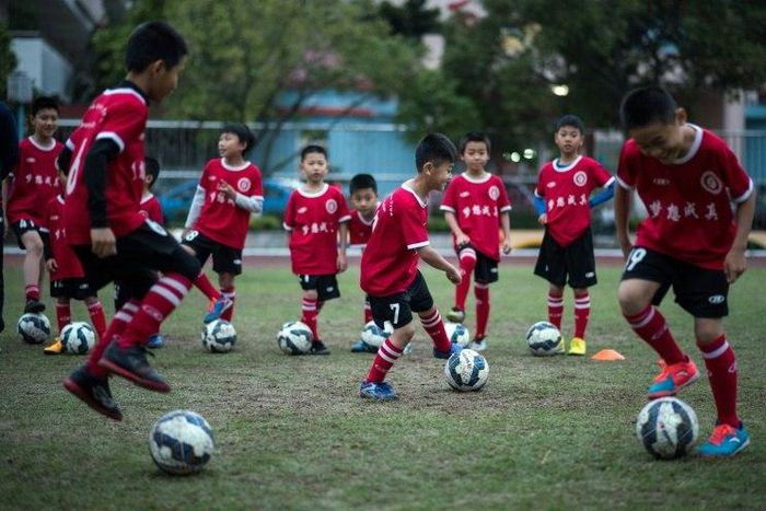 Children attend a football training session in the suburbs of Guangzhou, in southern China's Guangdong province
