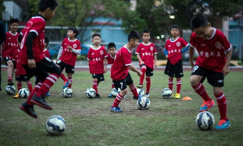 Children attend a football training session in the suburbs of Guangzhou, in southern China's Guangdong province