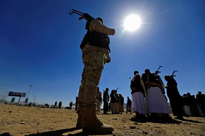A Yemeni man holds an AK-47 assault rifle as people gather in the capital Sanaa to show their support for Huthi rebels on December 19, 2018