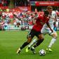 Manchester United's Marcus Rashford (L) vies with Swansea City's Alfie Mawson during their match in Swansea, south Wales on August 19