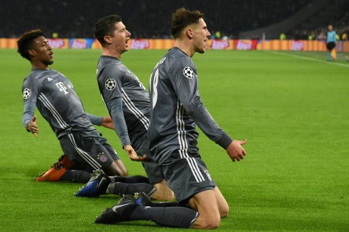 Bayern Munich's French winger Kingsley Coman (L) celebrates with Polish forward Robert Lewandowski (C) and Leon Goretzka in the trilling 3-3 draw at Ajax on Wednesday in Amsterdam.