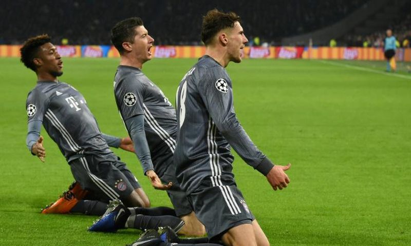 Bayern Munich's French winger Kingsley Coman (L) celebrates with Polish forward Robert Lewandowski (C) and Leon Goretzka in the trilling 3-3 draw at Ajax on Wednesday in Amsterdam.
