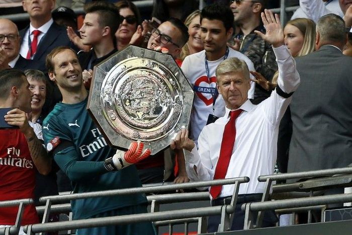 Arsenal's manager Arsene Wenger (R) and goalkeeper Petr Cech (L) hold up the trophy as they celebrate after their victory in the English FA Community Shield football match on August 6, 2017