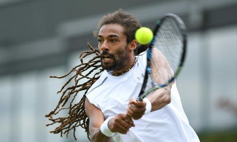Germany's Dustin Brown returns against Portugal's Joao Sousa during their men's singles first round match on the first day of the 2017 Wimbledon Championships at The All England Lawn Tennis Club in Wimbledon, southwest London, on July 3, 2017