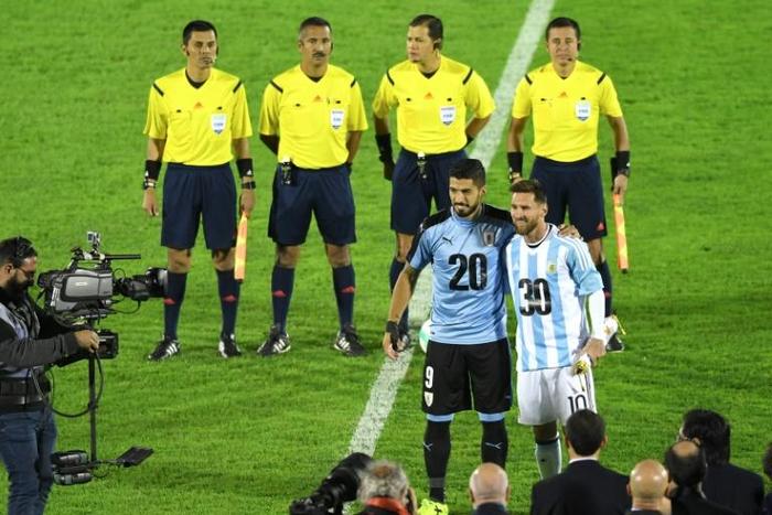 In this picture from last year, Barcelona pair Luis Suarez of Uruguay (left) and Argentina's Lionel Messi wear shirts backing the joint Argentina-Uruguay-Paraguay bid to host the 2030 World Cup