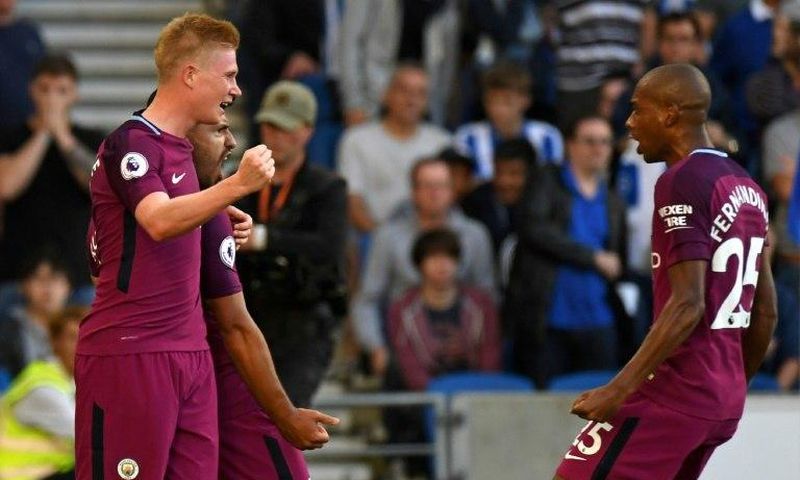 Manchester City's striker Sergio Aguero (2nd L) celebrates with midfielders Kevin De Bruyne (L) and Fernandinho (R) at the American Express Community Stadium in Brighton, southern England on August 12, 2017