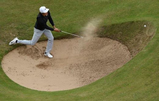 China's Li Haotong fails to get out of a bunker on the 12th hole on July 21, 2017