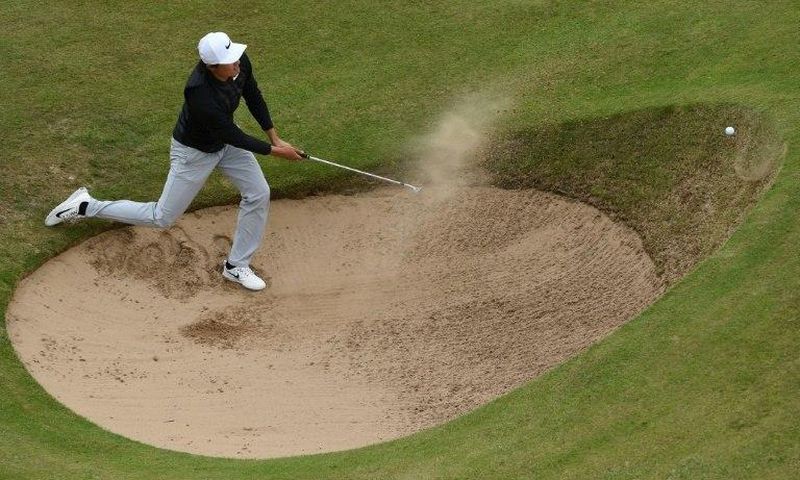 China's Li Haotong fails to get out of a bunker on the 12th hole on July 21, 2017