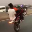 Kwesi Arthur on a stunt bike
