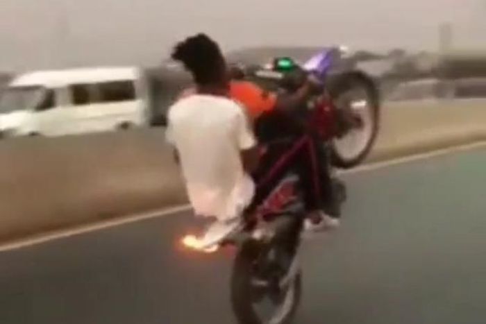 Kwesi Arthur on a stunt bike