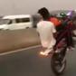 Kwesi Arthur on a stunt bike