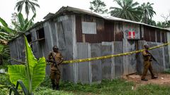 Nigerian drug enforcement officials guard a methamphetamine lab in the village of Obinugwu in the southeast of the country