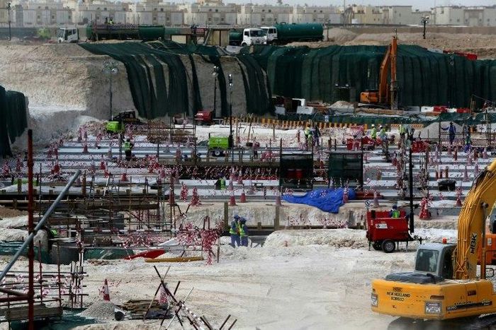 Foreign laborers work at the construction site of the al-Wakrah football stadium in 2015