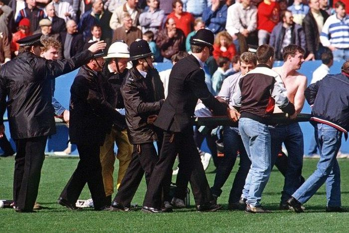 A football fan is carried from the pitch at Hillsborough stadium in Sheffield, central England following a crush in the stands on April 15, 1989