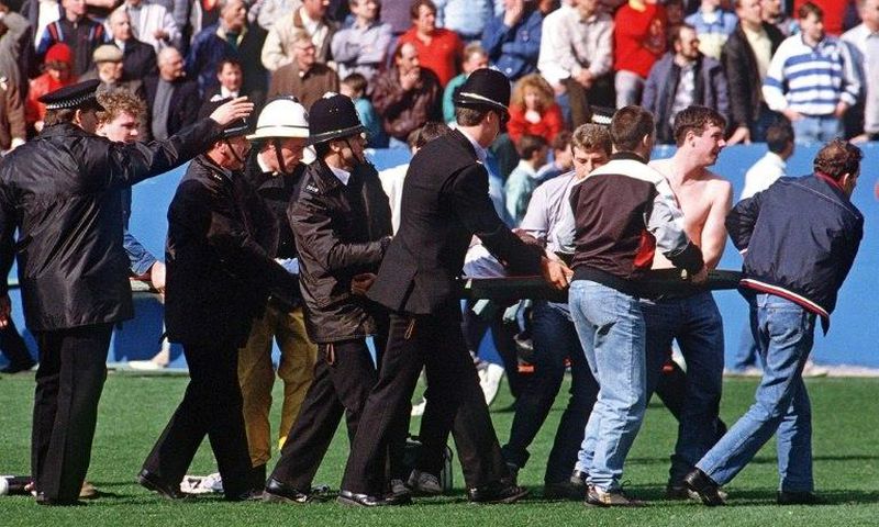A football fan is carried from the pitch at Hillsborough stadium in Sheffield on April 15, 1989