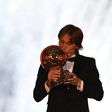Real Madrid's Croatian midfielder Luka Modric kisses the trophy after receiving the 2018 Men's Ballon d'Or