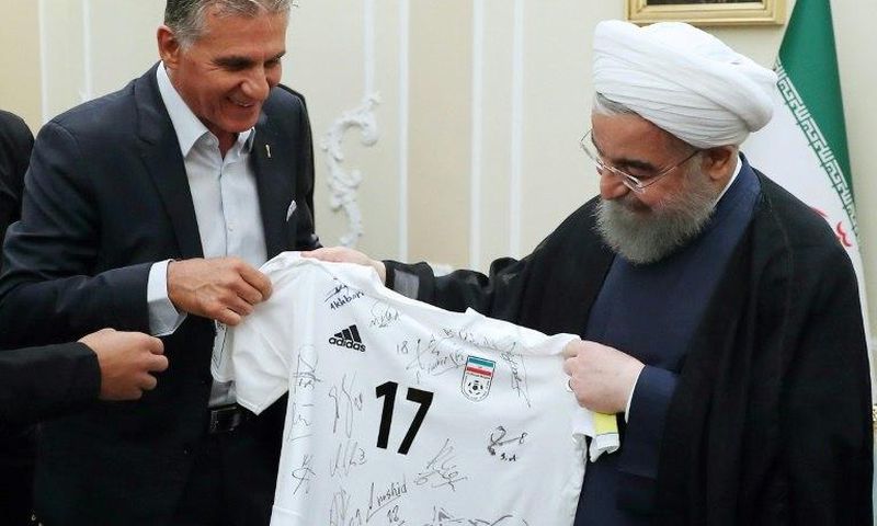 Football coach Carlos Queiroz (L) meets President Hassan Rouhani after taking the Iran team through to the Russia 2018 World Cup