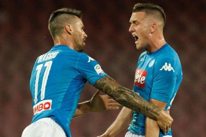 Napoli's midfielder Piotr Zielinski (R) celebrates after scoring with teammate during the Italian Serie A football match against Atalanta August 27, 2017