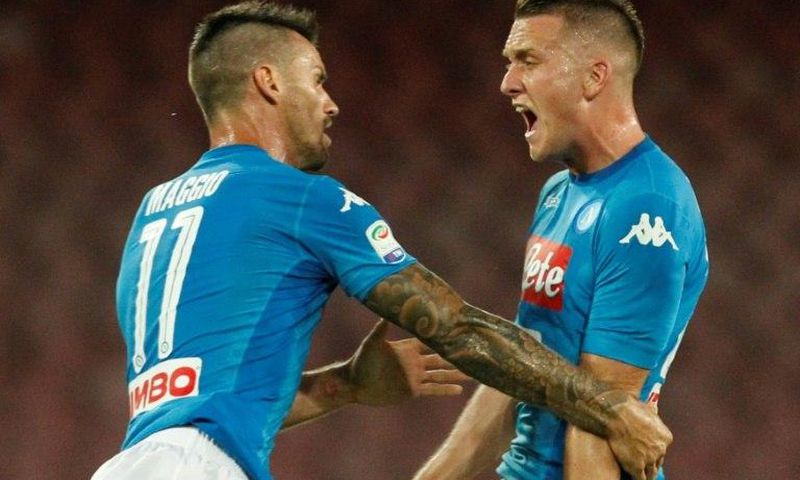 Napoli's midfielder Piotr Zielinski (R) celebrates after scoring with teammate during the Italian Serie A football match against Atalanta August 27, 2017