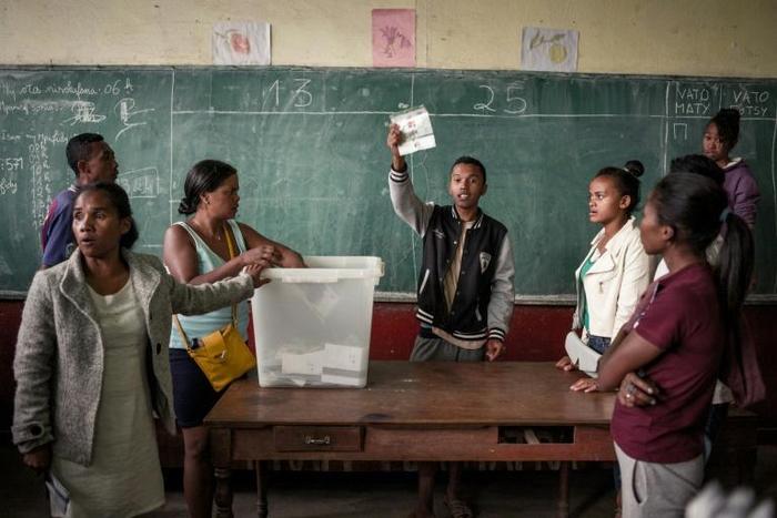 The big count: An electoral officer holds up a ballot paper as votes are tallied at a polling station in Antananarivo