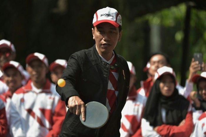 Indonesia's President Joko Widodo plays table tennis at the launch of his country's team for the 29th Southeast Asian Games taking place in Kuala Lumpur from August 19 to August 30