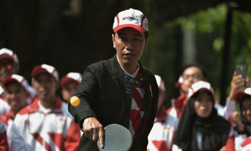 Indonesia's President Joko Widodo plays table tennis at the launch of his country's team for the 29th Southeast Asian Games taking place in Kuala Lumpur from August 19 to August 30