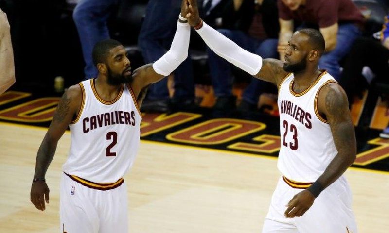Kyrie Irving (L) and LeBron James of the Cleveland Cavaliers high five against the Golden State Warriors in Game 4 of the 2017 NBA Finals at Quicken Loans Arena on June 9, 2017 in Cleveland, Ohio