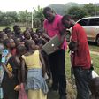 John Dumelo educating some children