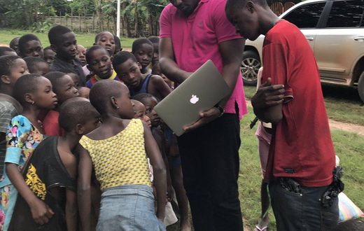 John Dumelo educating some children