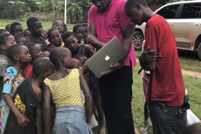 John Dumelo educating some children