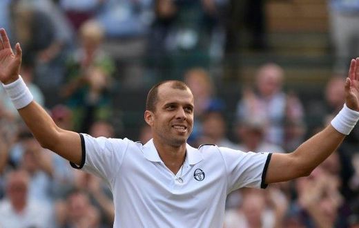 Luxembourg's Gilles Muller acknowledges the Centre Court crowd after beating Spain's Rafael Nadal at Wimbledon on July 10, 2017