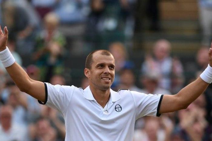 Luxembourg's Gilles Muller acknowledges the Centre Court crowd after beating Spain's Rafael Nadal at Wimbledon on July 10, 2017