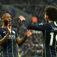 Raheem Sterlin celebrates with Manchester City team-mate Leroy Sane