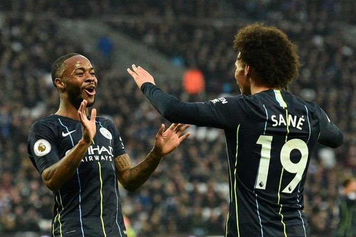 Raheem Sterlin celebrates with Manchester City team-mate Leroy Sane