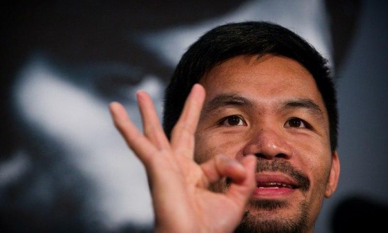 Manny Pacquiao touched down in Brisbane late Saturday from Manila with a large entourage for his World Boxing Organization welterweight title bout at Suncorp Stadium next weekend
