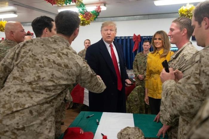 US President Donald Trump and First Lady Melania Trump greet members of the US military during an unannounced trip to Al Asad Air Base in Iraq on December 26, 2018