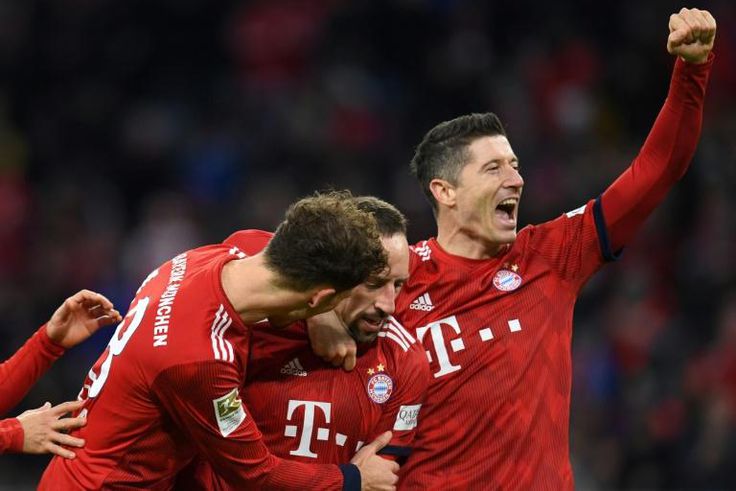Bayern Munich's Polish striker Robert Lewandowski (R), who scored their first two goals, celebrates after Franck Ribery netted a late third in Saturday's 3-0 win against Nuremberg to lift the defending champions to third in the league table.