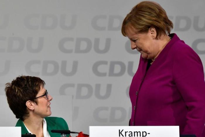 Merkel (R) got a political boost after her handpicked successor, Annegret Kramp-Karrenbauer (L), become newly-elected leader of her party