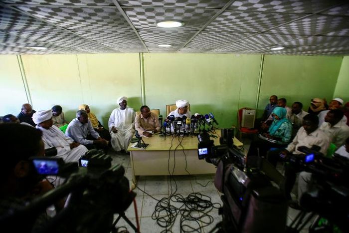 Idris Suleiman (C), Sudan's ex-minister of international cooperation and political secretary of the Popular Congress Party, speaks during a press conference at the party's headquarters in the capital Khartoum on December 26, 2018