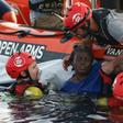 Members of the Spanish NGO Proactiva Open Arms rescue a woman in the Mediterranean sea in July 2018
