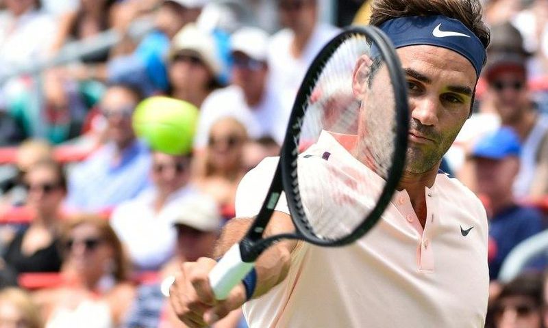 Roger Federer of Switzerland hits a return shot against Peter Polansky of Canada during day six of the Rogers Cup in Montreal, Canada