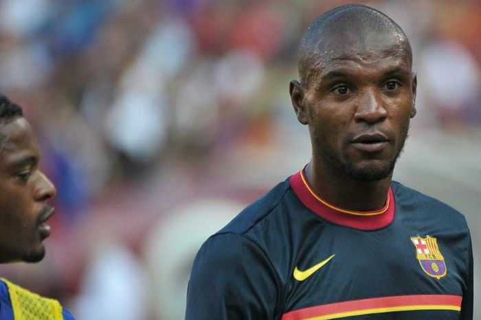 Eric Abidal (right) spent six years as a Barcelona player