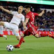 Connor Lade (R) of New York Red Bulls takes a shot as Jeff Larentowicz of Atlanta United defends in the first half during the Eastern Conference Finals Leg 2 match, at Red Bull Arena in Harrison, New Jersey, on November 29, 2018