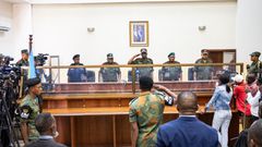 Military officers stand in the dock during the trial of former Congolese President Joseph Kabila in Kinshasa, Democratic Republic of Congo, Tuesday, Sept. 30, 2025 (AP Photo/ Samy Ntumba Shambuyi)