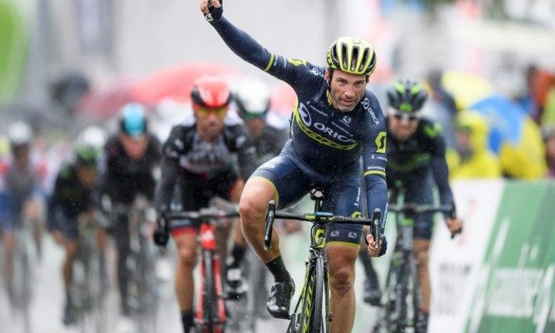 Switzerland's Michael Albasini of Team Orica-Scott (C) recats as he crosses the finish line to win the first stage of Tour de Romandie UCI protour cycling race, a 173km ride from Aigle to Champery on April 26, 2017