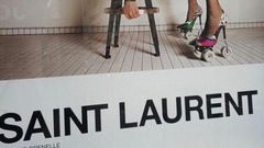 Yves Saint Laurent have been accused of 'degrading' models and 'inciting rape' with a new French advertising campaign. One image (above) shows a model in a leotard and roller skate stilettos bending over a stool