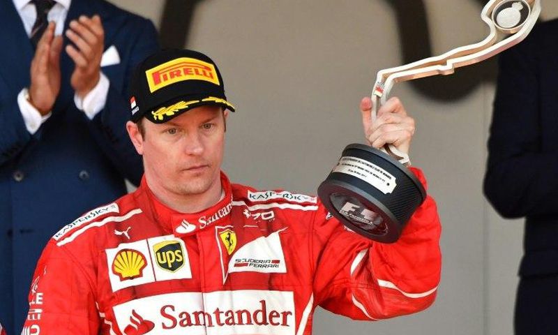 Ferrari's Finnish driver Kimi Raikkonen holds his trophy as he celebrates on the podium after the Monaco Formula 1 Grand Prix at the Monaco street circuit, on May 28, 2017